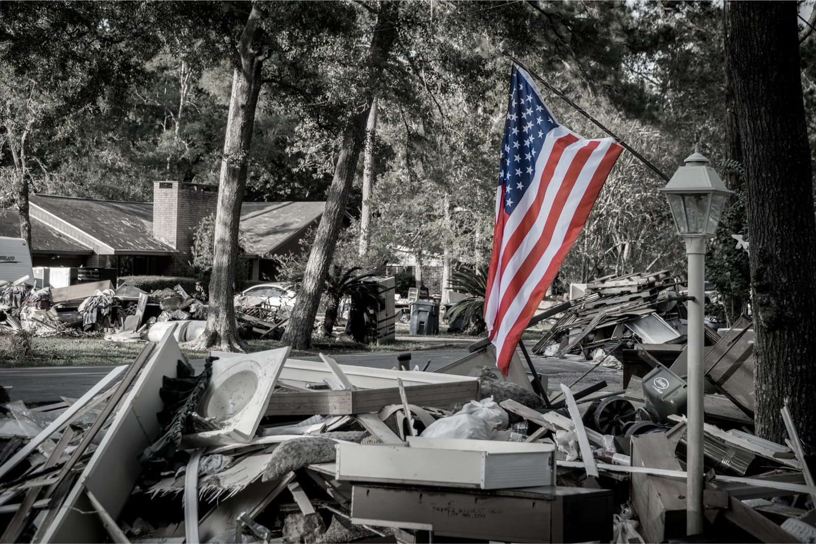 American-Flag-next-to-a-pile-of-trash-from-a-home-that-was-hit-by-Hurricane-Harvey–1